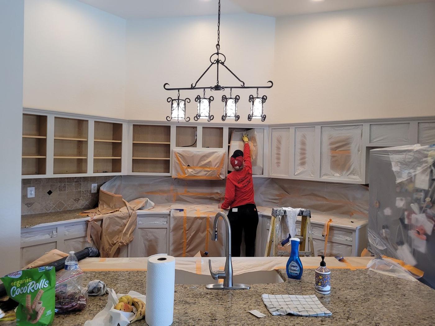 Counters and appliances masked before spraying