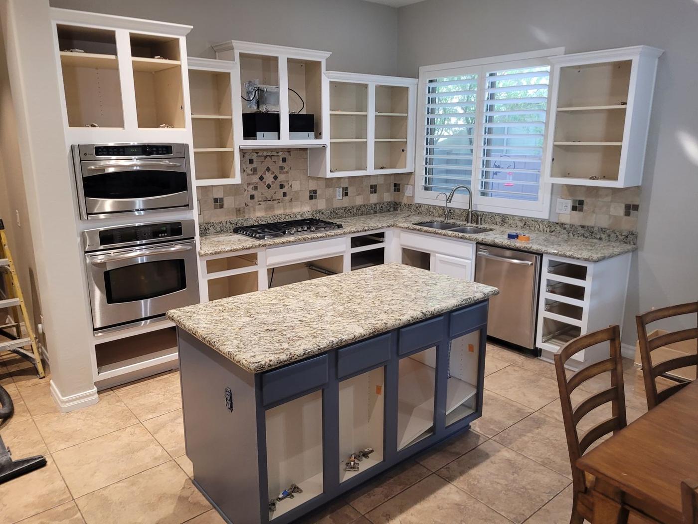 White perimeter cabinets with a gray island