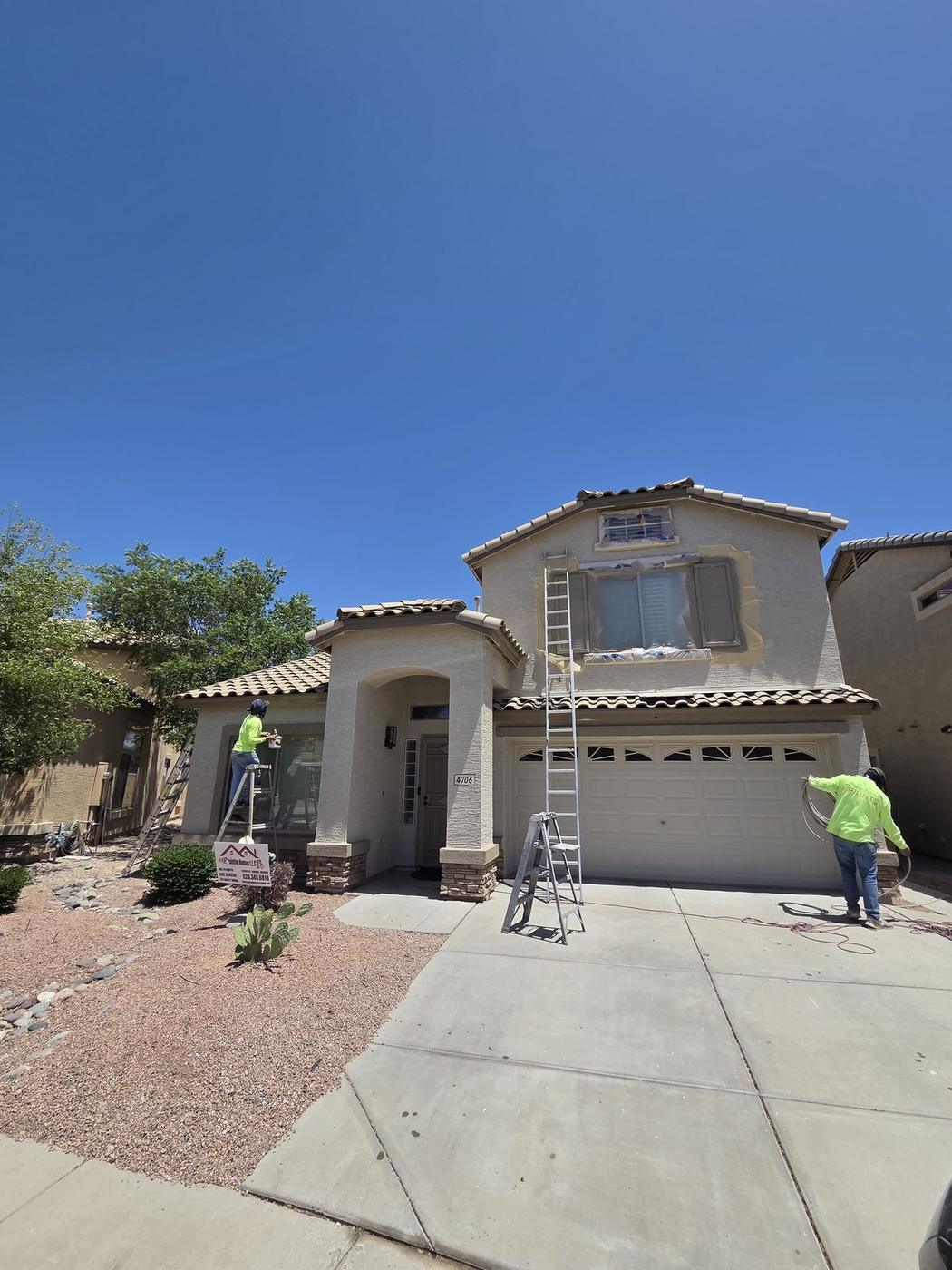 Our crew painting a stucco exterior